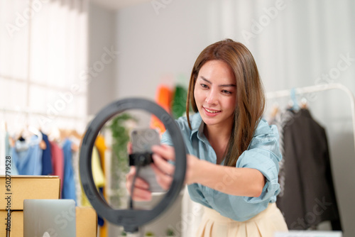 Asian woman beauty Vlogger preparing equipment for live broadcasting online selling cloths on social media. Business online influencer on social media concept. Online Selling. Online Shopping.