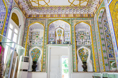 Interior painted wall decorations of harem building in former Emir country residence Sitorai Mohi Xosa in Bukhara, Uzbekistan. Real vase combined with picture of bouquet of flowers is classic element photo