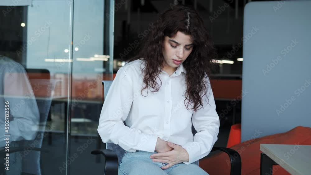 Stockvideon Beautiful freelance girl in a white shirt with curly hair