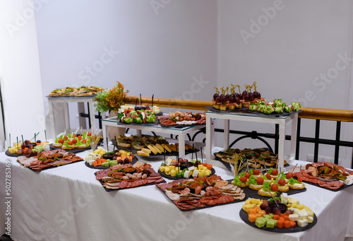 Table with canapes and meat and cheese slicing. High quality photo