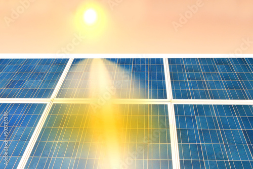 Solar panels for electricity production illuminated by reflected sun rays photo