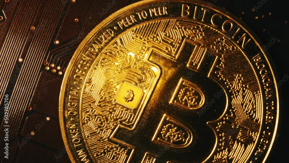 Macro view of golden bitcoin on microchip.