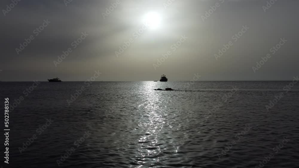 A swimmer swims along the shore at dawn. High quality 4k footage A swimmer swims along the shore at dawn. High quality 4k footage
