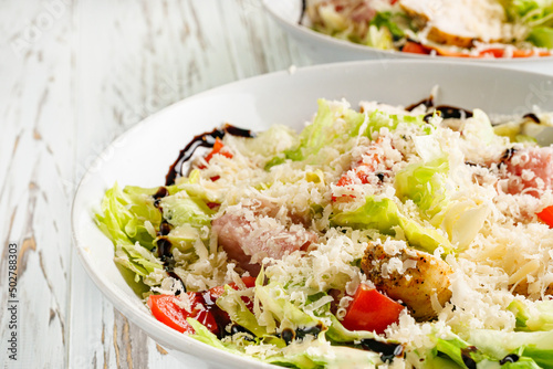 Caesar salad on a white wooden rustic background