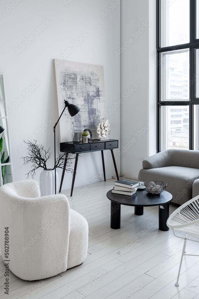 Fototapeta premium modern minimalistic interior design of light bright monochrome room with black and white furniture, clean white walls and huge windows