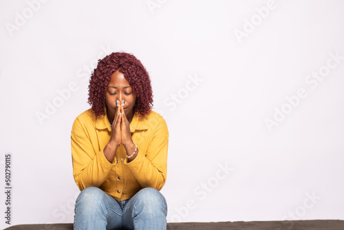 Fototapeta young african lady saying her prayers