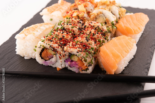 sushi collection with black chopsticks and soy sauce on white background Closeup of delicious japanese food with sushi roll