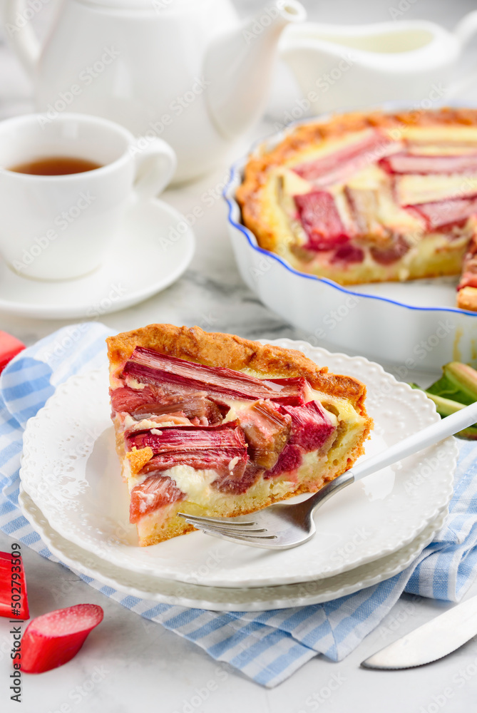 A slice of rhubarb pie or tart  on a white plate. Summer healthy dessert. Selective focus