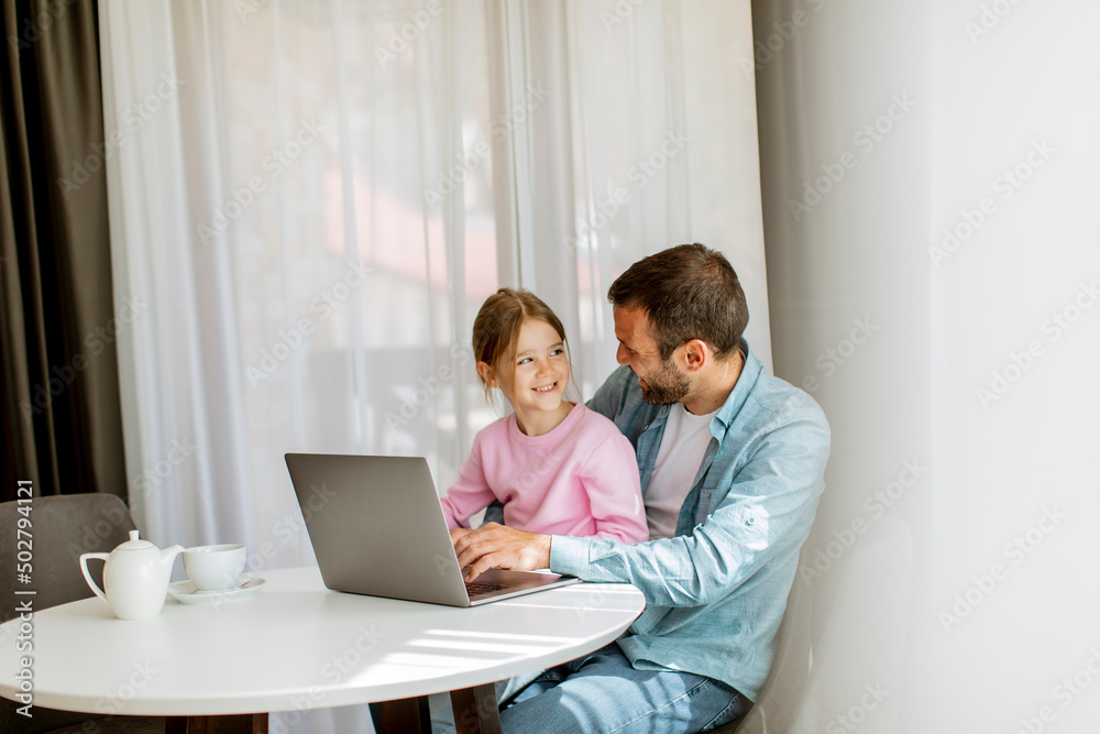 Father and daughter using laptop computer together Father and daughter using laptop computer together