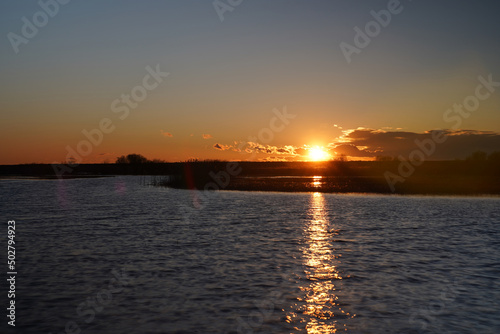 Sunset over Biebrza River, spring landscape with river, sun