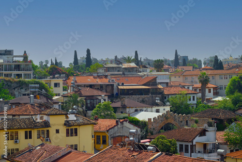 old town homes with green trees, blue sky, back ground. historical detached buildings worth seeing in Antalya Turkey.