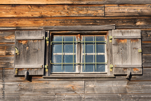 Fototapet wooden facade of old boathouse with window