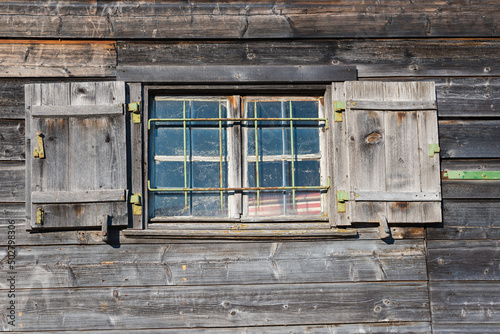 Canvastavla wooden facade of old boathouse with window
