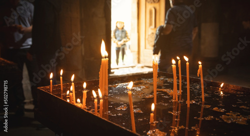 Burning candles in a church.