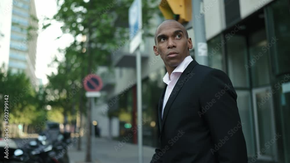 Concentrated African businessman walking on the street Concentrated African businessman walking on the street