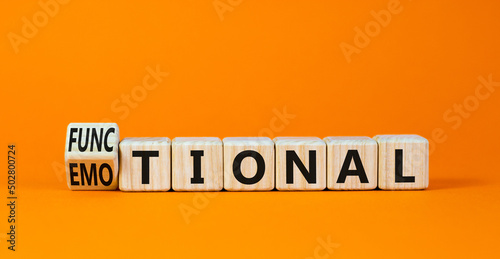 Functional or emotional symbol. Turned wooden cubes and changed the word emotional to functional. Beautiful orange table orange background, copy space. Business and functional or emotional concept.