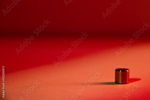 Neodymium magnet on red background photo