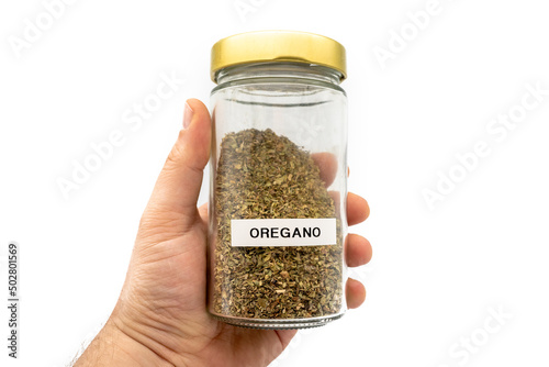 Glass with oregano in a hand