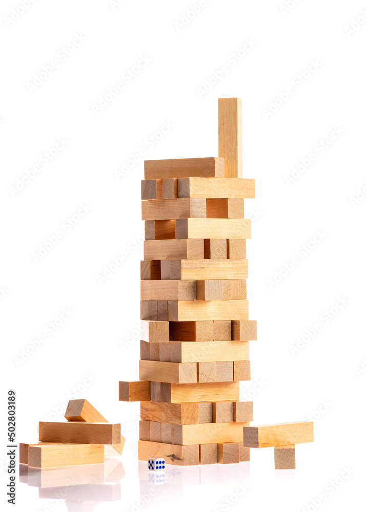 Jenga tower made of wooden blocks falling on white background