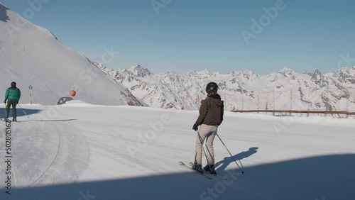 Woman Skiing Along Snow In Solden photo