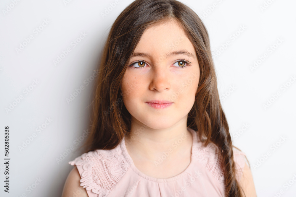 pensive cute child over white background on studio