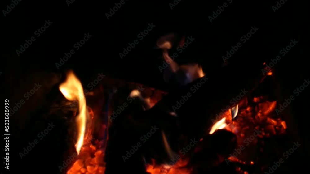 Firewood on fire in a home fireplace Firewood on fire in a home fireplace