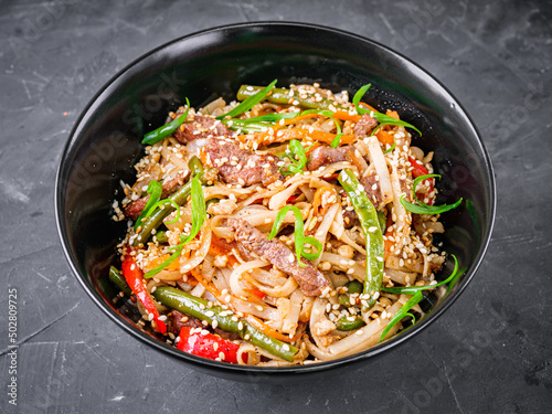 delicious chinese fried noodles on a black background