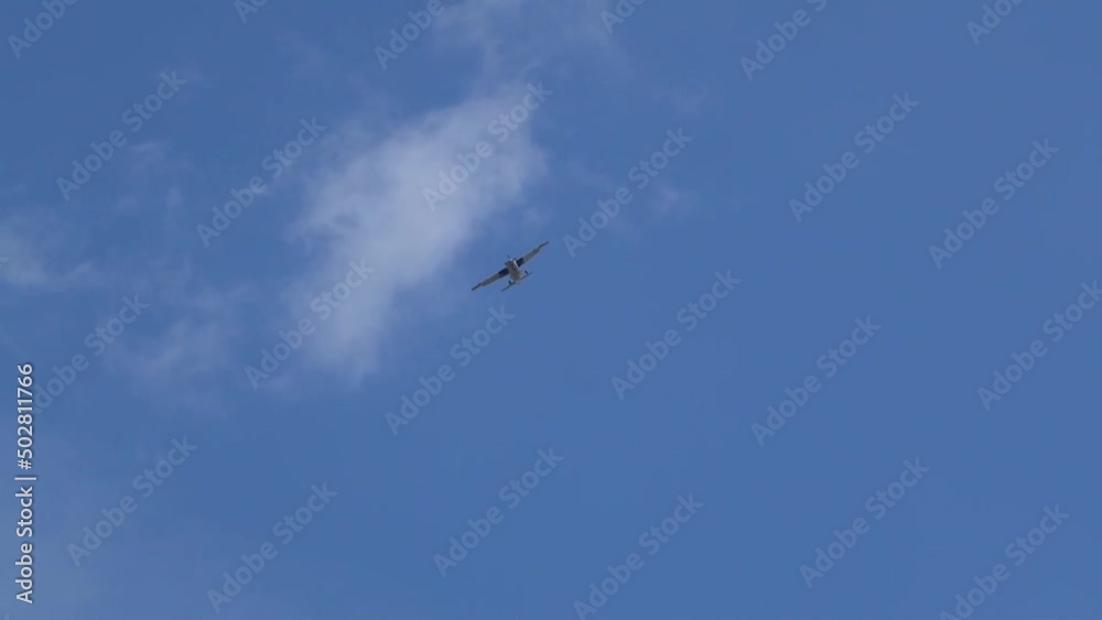 light aircraft descending to land, blue sky light aircraft descending to land, blue sky