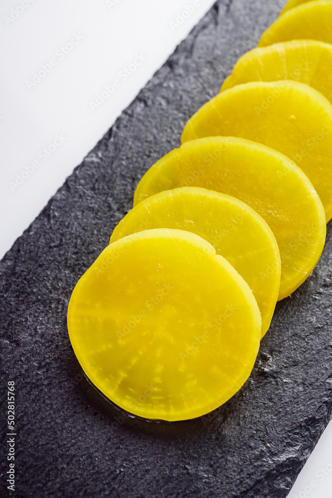 takuan traditional japanese marinated daikon radish on a white