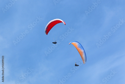  Paragliders in a blue sky 