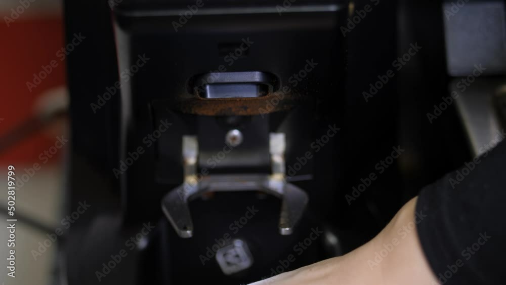 Process of semi-automatic filling of ground coffee beans into a mold for a coffee machine.