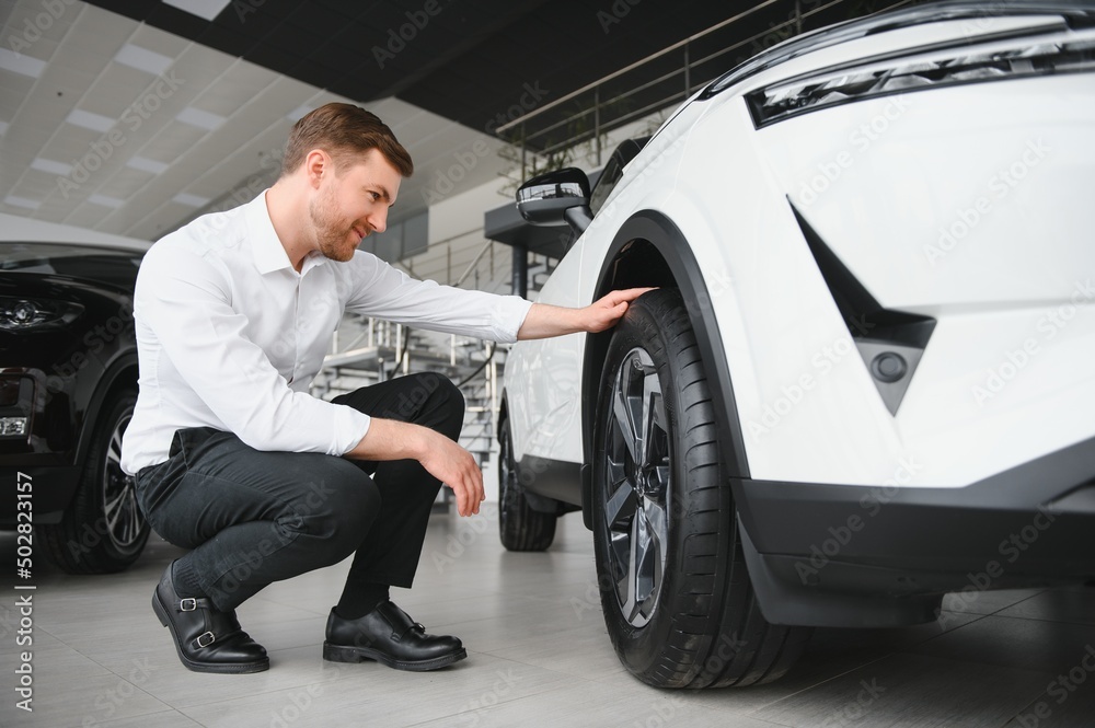 Man buying a car at a showroom Man buying a car at a showroom