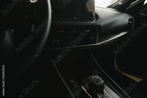 car interior. Modern car speedometer and illuminated dashboard. Luxurious car instrument cluster. Close up shot of hybrid car instrument panel