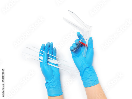 Photos Doctor holding disposable vaginal speculum and gynecological examination kit on