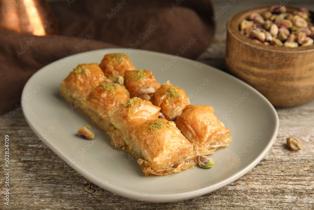Delicious baklava with pistachios on wooden table
