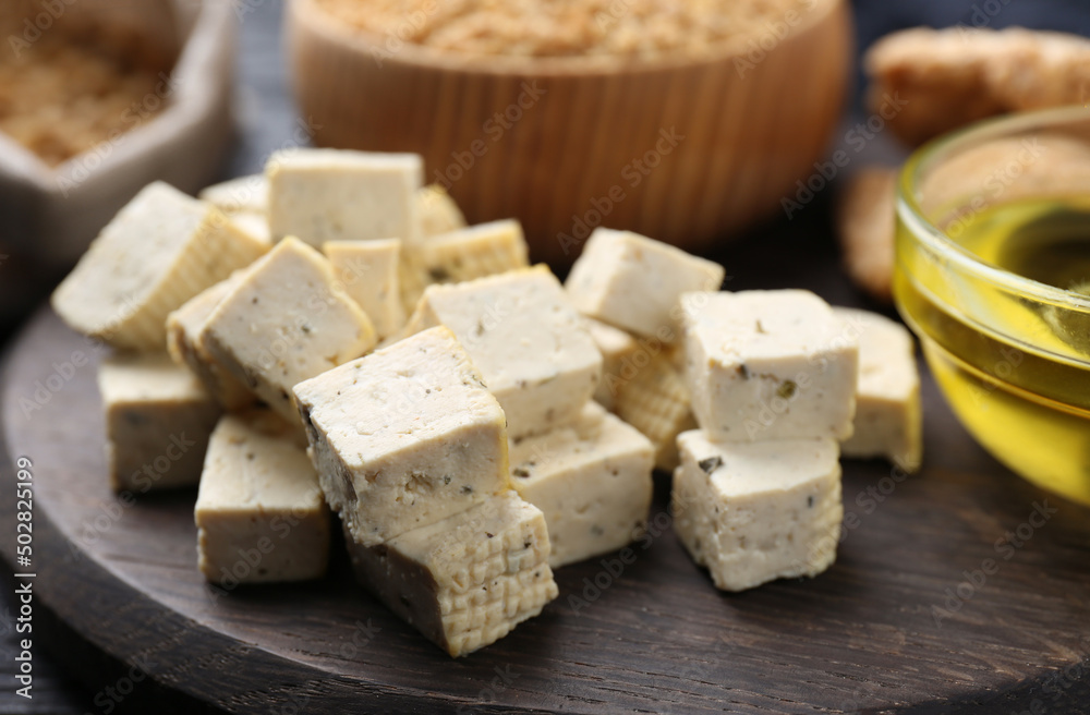 Natural tofu on wooden board, closeup. Soy product