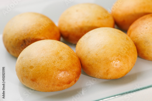 pão de batata assado e fresquinho sobre prato branco 