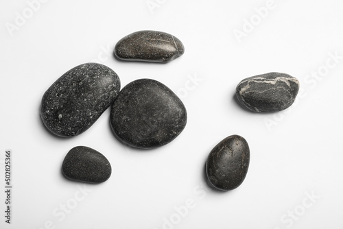 Many different stones on white background  top view
