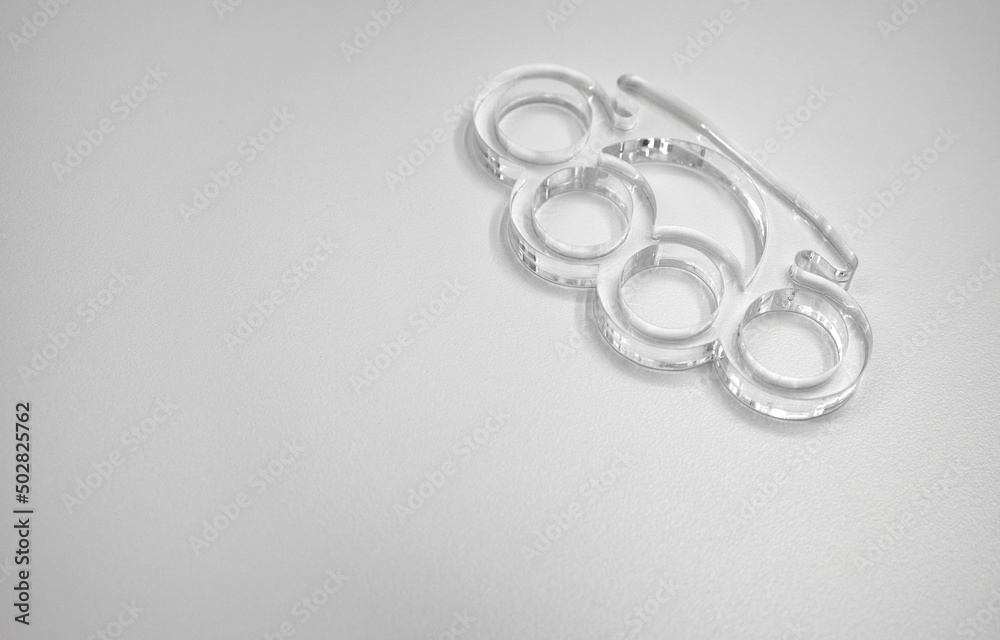 Glass brass knuckles on white isolate. Brass knuckles for the hand made