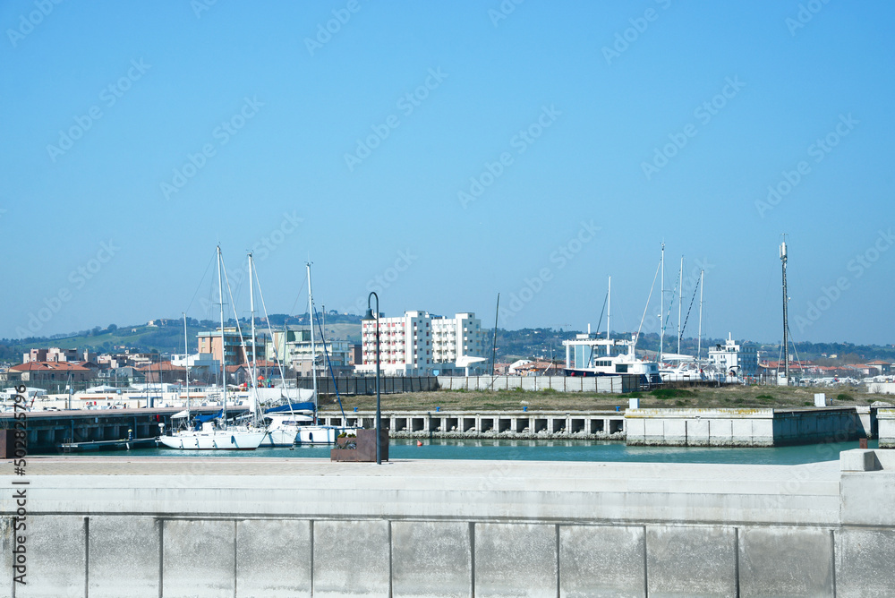 Fototapeta premium Beautiful view of city from pier with boats