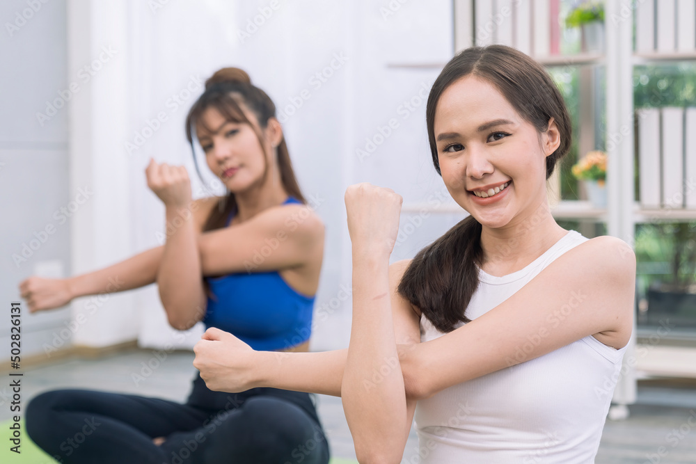 Couple love and romance on holiday. Lesbian women exercising stretching at the living room. woman yoga. Sport woman. Couple love and romance on holiday. Lesbian women exercising stretching at the living room. woman yoga. Sport woman.