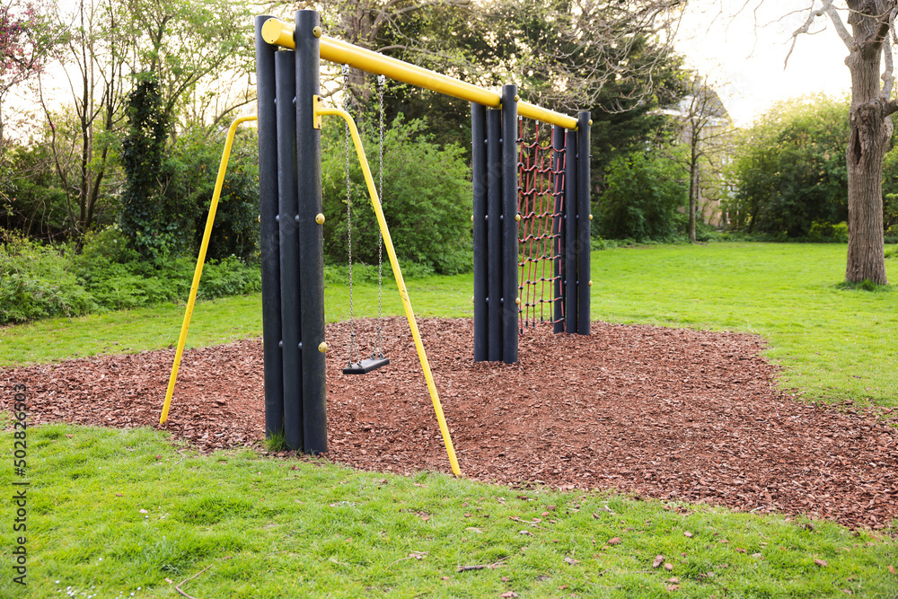 Fototapeta premium Beautiful green park with playground. Outdoor recreation