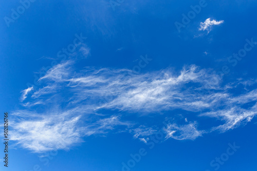 daytime blue sky with wind scattered white cirrus clouds as a natural backdrop © westermak15
