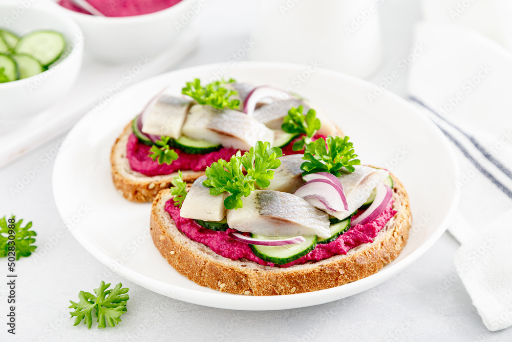 Sandwiches, toasts with salted herring and beetroot pate