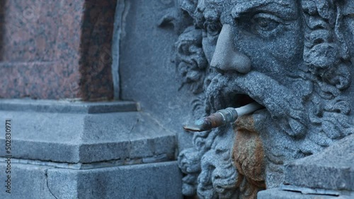 stone head of a man ancient parched fountain panorama