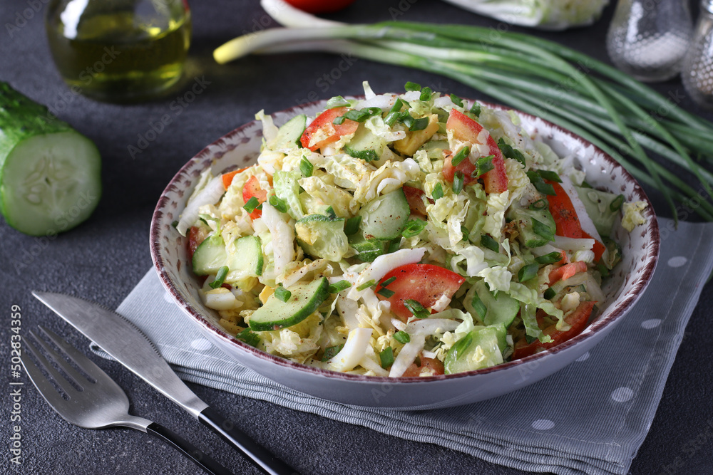 Salad with Chinese cabbage, tomatoes, chives, eggs and cucumber, dressed with olive oil
