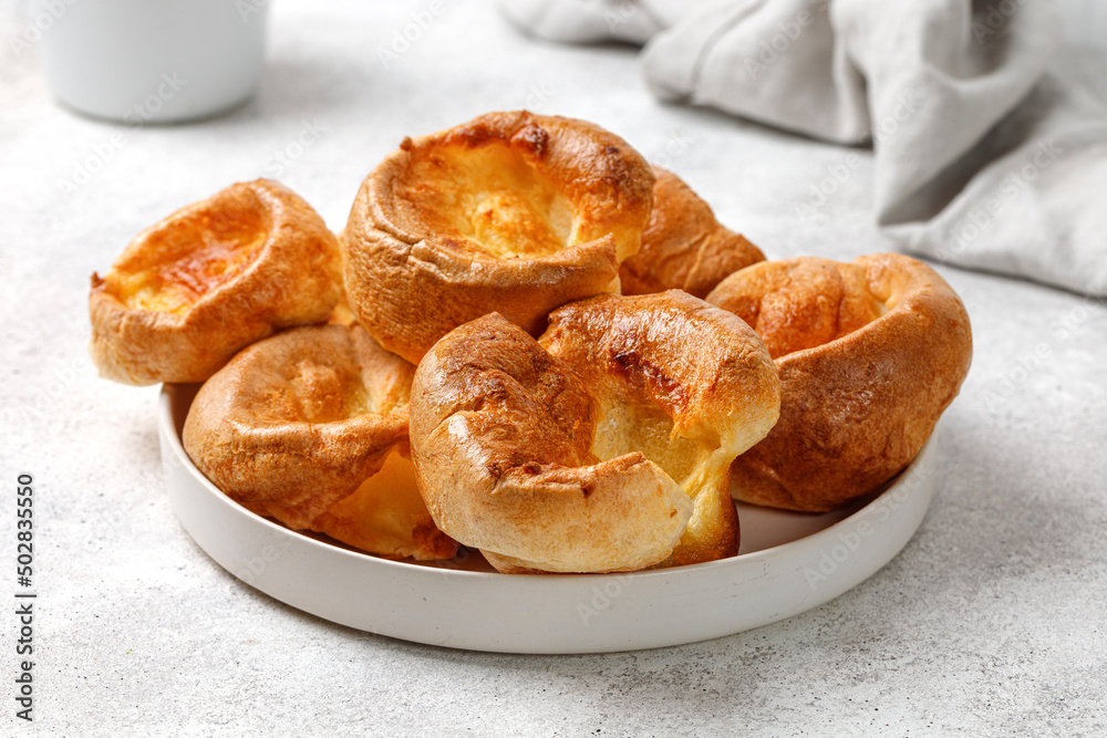 Yorkshire pudding on plate close up. English traditional food. Grey background