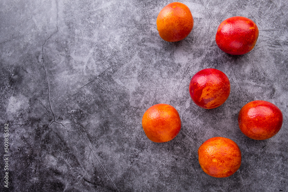 Red oranges on grey background. Top view, copy space Red oranges on grey background. Top view, copy space