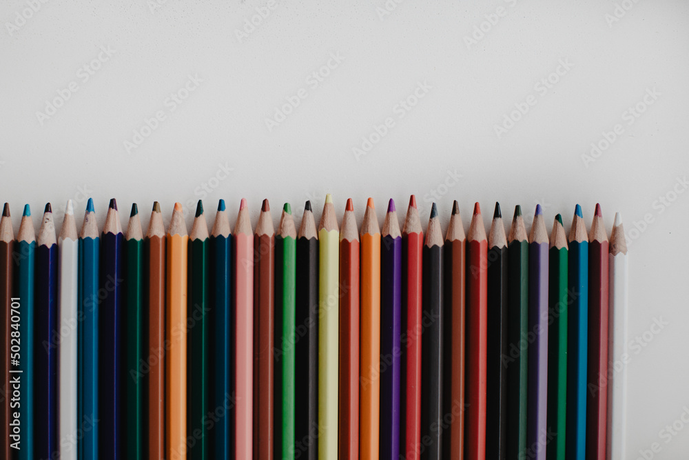 Different colored pencils on a white table Different colored pencils on a white table