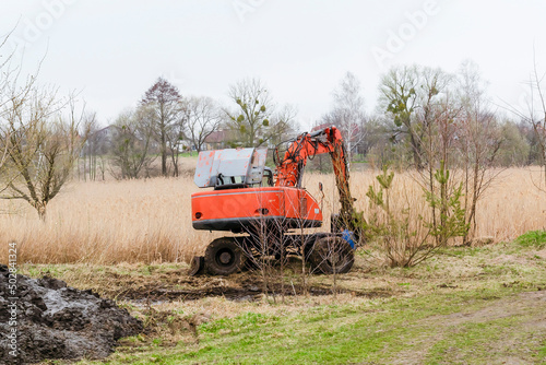 Modern tractor machinery plowing agricultural field meadow at farm at spring autumn. Farmer cultivating and make soil tillage before seeding plants and crops  nature countryside rural scene